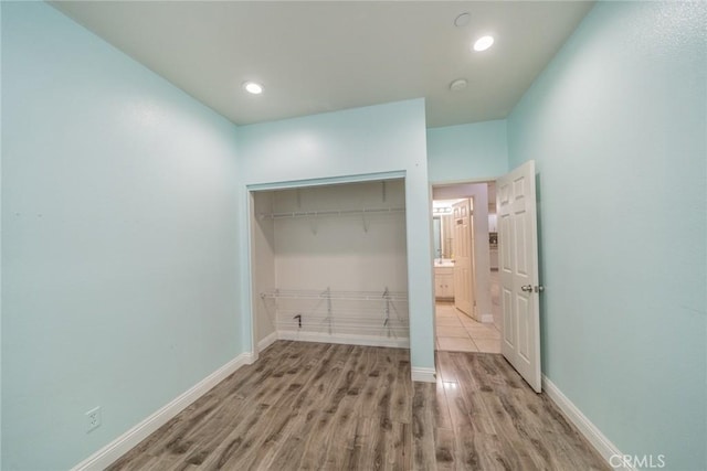7404 Marshall Ct, Highland, CA 92346 - laundry area with wood finished floors and recessed lighting