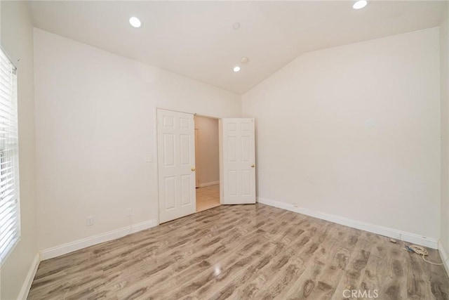 7404 Marshall Ct, Highland, CA 92346 - empty room featuring light wood-style flooring, vaulted ceiling, baseboards, and recessed lighting