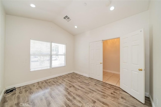 7404 Marshall Ct, Highland, CA 92346 - unfurnished bedroom featuring wood finished floors, vaulted ceiling, baseboards, and recessed lighting
