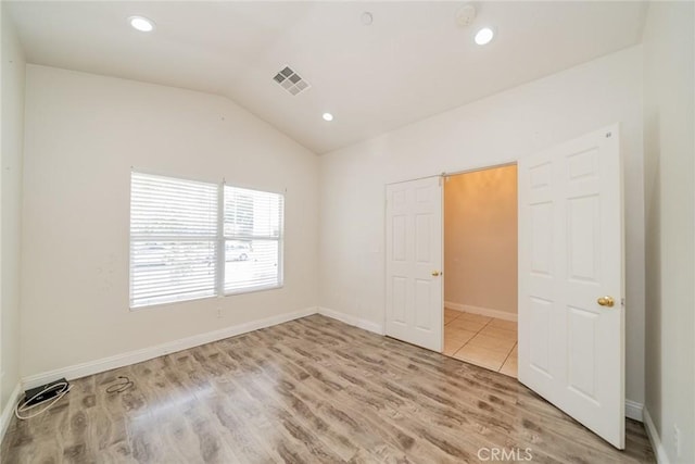 7404 Marshall Ct, Highland, CA 92346 - unfurnished bedroom featuring wood finished floors, vaulted ceiling, and recessed lighting