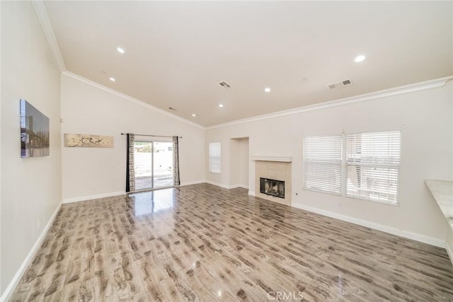 7404 Marshall Ct, Highland, CA 92346 - unfurnished living room featuring wood finished floors, ornamental molding, baseboards, a tiled fireplace, and lofted ceiling
