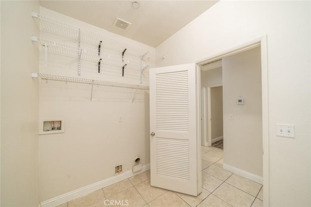 7404 Marshall Ct, Highland, CA 92346 - laundry area with electric dryer hookup, hookup for a washing machine, light tile patterned floors, and baseboards