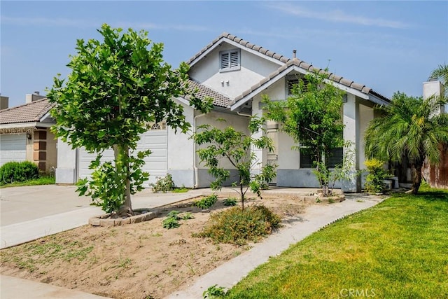 7404 Marshall Ct, Highland, CA 92346 - view of front of property with a tile roof, stucco siding, an attached garage, and driveway