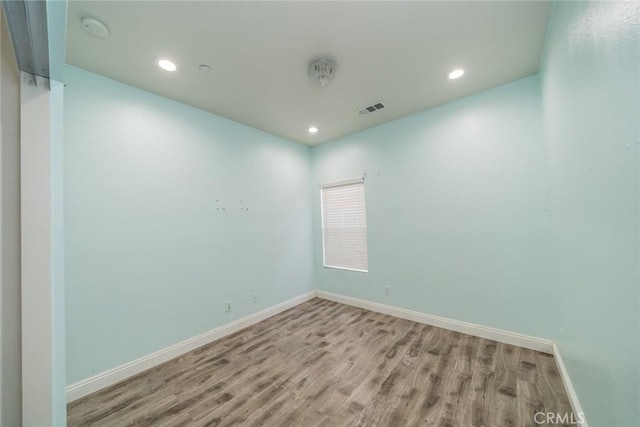 7404 Marshall Ct, Highland, CA 92346 - empty room with wood finished floors, recessed lighting, baseboards, and a smoke detector