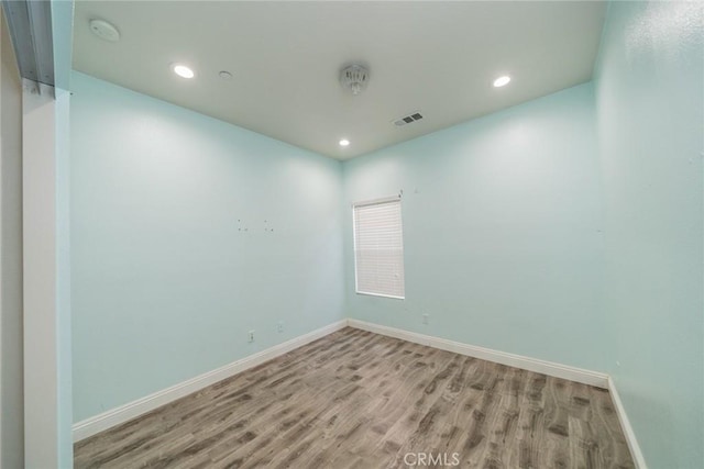 7404 Marshall Ct, Highland, CA 92346 - spare room with wood finished floors, a smoke detector, and recessed lighting