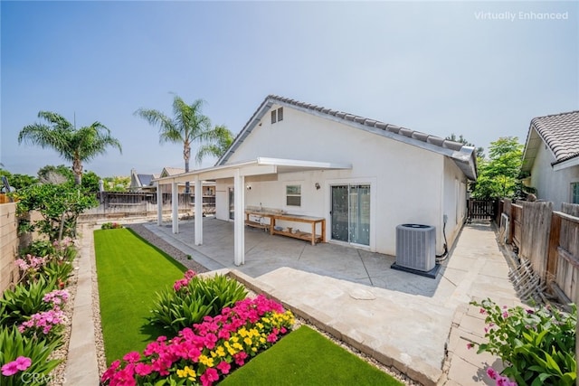 7404 Marshall Ct, Highland, CA 92346 - back of house with cooling unit, a fenced backyard, stucco siding, and a patio