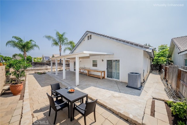 7404 Marshall Ct, Highland, CA 92346 - back of property featuring central AC, a fenced backyard, a patio, and stucco siding