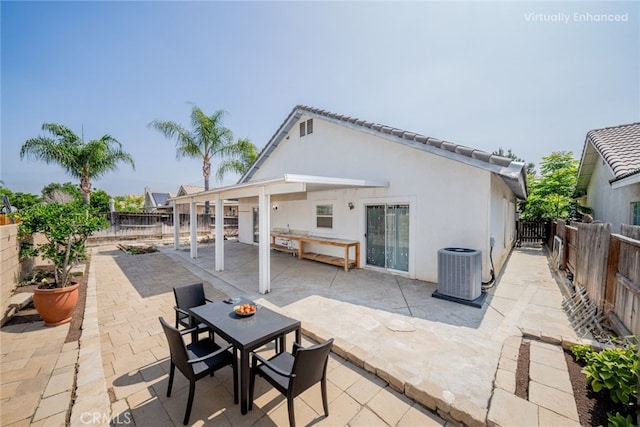 7404 Marshall Ct, Highland, CA 92346 - back of house with a fenced backyard, stucco siding, a patio, and outdoor dining area