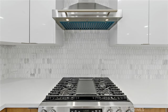 19617 Enslow Dr, Carson, CA 90746 - kitchen with range hood, stainless steel gas range oven, white cabinets, and decorative backsplash