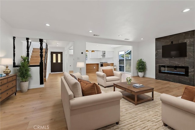 19617 Enslow Dr, Carson, CA 90746 - living room with light wood-style floors, recessed lighting, a fireplace, baseboards, and stairs