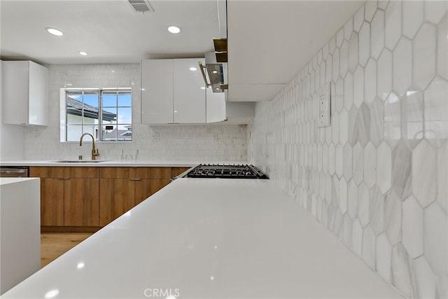 19617 Enslow Dr, Carson, CA 90746 - kitchen featuring a sink, brown cabinets, white cabinets, decorative backsplash, and recessed lighting