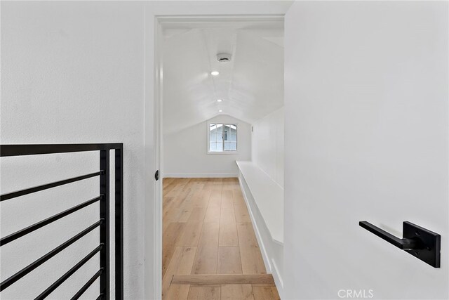 19617 Enslow Dr, Carson, CA 90746 - stairway featuring radiator, hardwood / wood-style flooring, vaulted ceiling, and baseboards