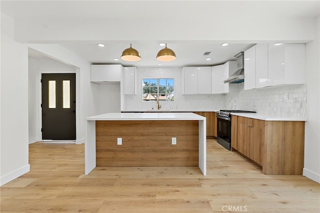 19617 Enslow Dr, Carson, CA 90746 - kitchen featuring modern cabinets, gas range, white cabinetry, wall chimney exhaust hood, and recessed lighting
