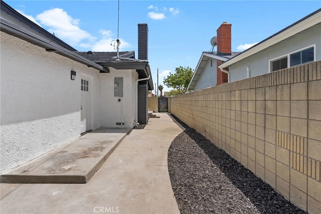 19617 Enslow Dr, Carson, CA 90746 - view of side of home featuring fence, stucco siding, and a patio