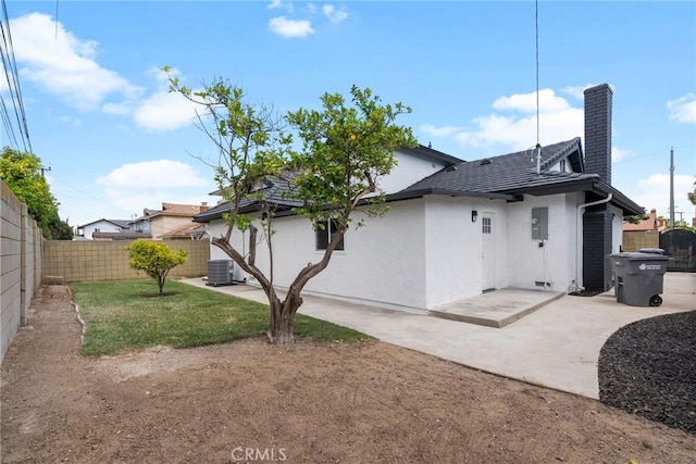 19617 Enslow Dr, Carson, CA 90746 - back of property with a patio area, a chimney, stucco siding, and central AC