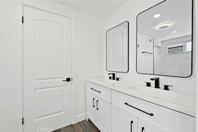 19617 Enslow Dr, Carson, CA 90746 - bathroom with double vanity, wood finished floors, baseboards, and a shower