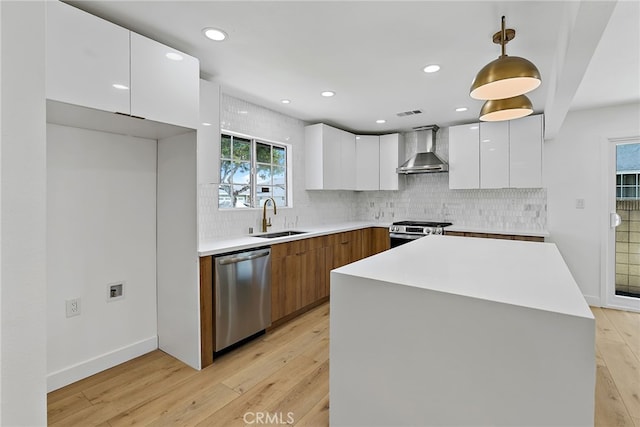 19617 Enslow Dr, Carson, CA 90746 - kitchen featuring stainless steel appliances, modern cabinets, a sink, wall chimney exhaust hood, and white cabinets