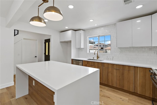 19617 Enslow Dr, Carson, CA 90746 - kitchen featuring modern cabinets, a sink, dishwasher, brown cabinets, and white cabinetry