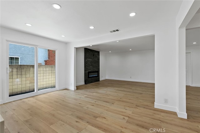 19617 Enslow Dr, Carson, CA 90746 - unfurnished living room featuring light wood-style flooring, recessed lighting, a fireplace, and baseboards