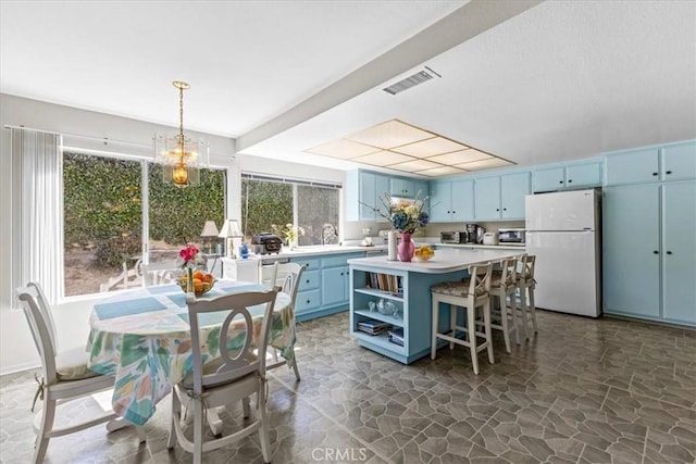 2015 E Hillman Cir, Orange, CA 92867 - kitchen featuring freestanding refrigerator, blue cabinets, stone flooring, and plenty of natural light