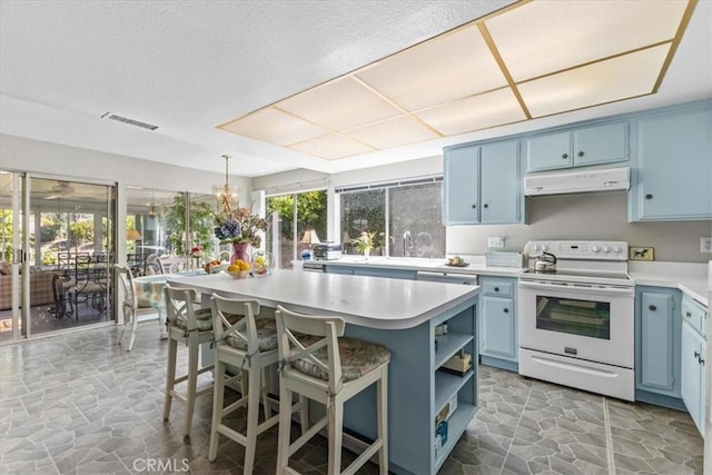2015 E Hillman Cir, Orange, CA 92867 - kitchen featuring white range with electric stovetop, blue cabinetry, under cabinet range hood, stone floors, and a textured ceiling