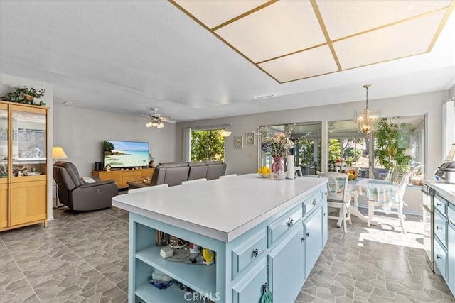 2015 E Hillman Cir, Orange, CA 92867 - kitchen with stone flooring, a center island, a chandelier, and light countertops