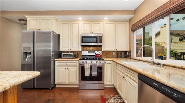 13819 Dogwood Ave, Chino, CA 91710 - kitchen featuring stainless steel appliances, a sink, tasteful backsplash, cream cabinets, and recessed lighting