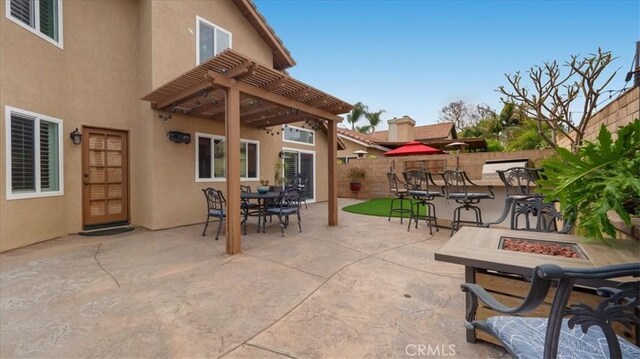 13819 Dogwood Ave, Chino, CA 91710 - view of patio with a fire pit, a pergola, and fence