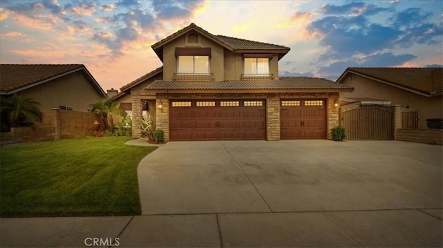 13819 Dogwood Ave, Chino, CA 91710 - view of front facade featuring stone siding, a gate, concrete driveway, a tile roof, and stucco siding