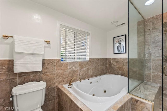 4428 Saugus Ave, Sherman Oaks, CA 91403 - full bathroom featuring a whirlpool tub, toilet, tile walls, and wainscoting