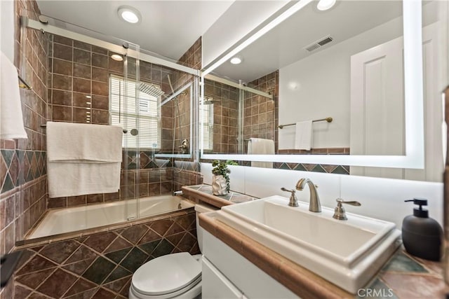 4428 Saugus Ave, Sherman Oaks, CA 91403 - bathroom featuring tile walls, tiled shower / bath, toilet, vanity, and recessed lighting