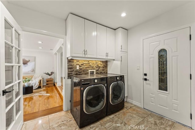4428 Saugus Ave, Sherman Oaks, CA 91403 - washroom with cabinet space, washing machine and clothes dryer, and light marble finish flooring