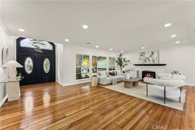 4428 Saugus Ave, Sherman Oaks, CA 91403 - living room featuring light wood-style floors, ornamental molding, a lit fireplace, baseboards, and recessed lighting
