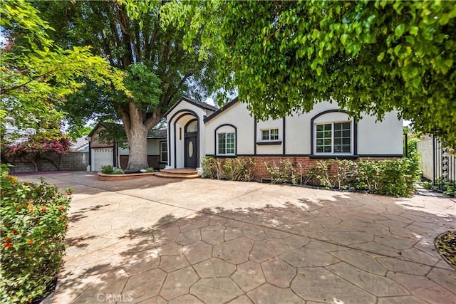 4428 Saugus Ave, Sherman Oaks, CA 91403 - view of front of property with stucco siding, concrete driveway, an attached garage, and brick siding