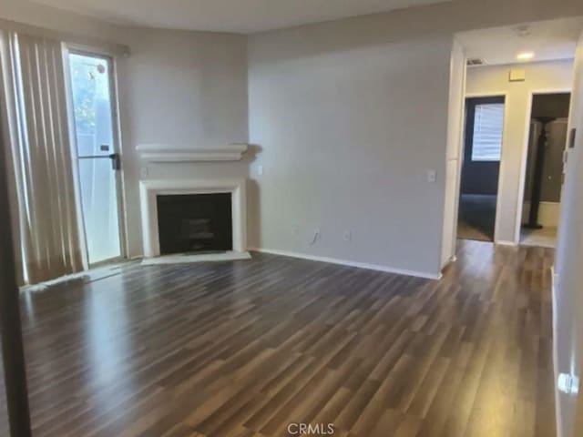 2805 W W Ave K12, Unit 143, Lancaster, CA 93536 - unfurnished living room with dark wood finished floors, baseboards, and a fireplace