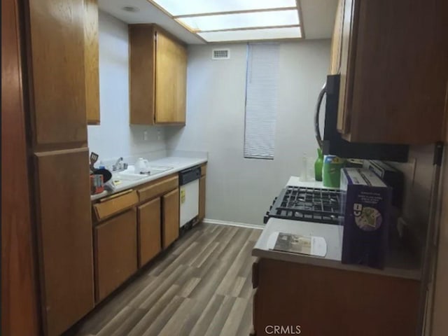 2805 W W Ave K12, Unit 143, Lancaster, CA 93536 - kitchen featuring dishwasher, a sink, wood finished floors, light countertops, and baseboards