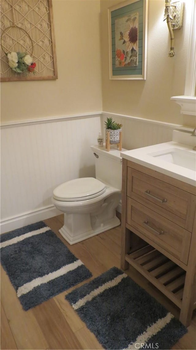 306 Vista Trucha, Newport Beach, CA 92660 - half bathroom with a wainscoted wall, toilet, wood finished floors, and vanity