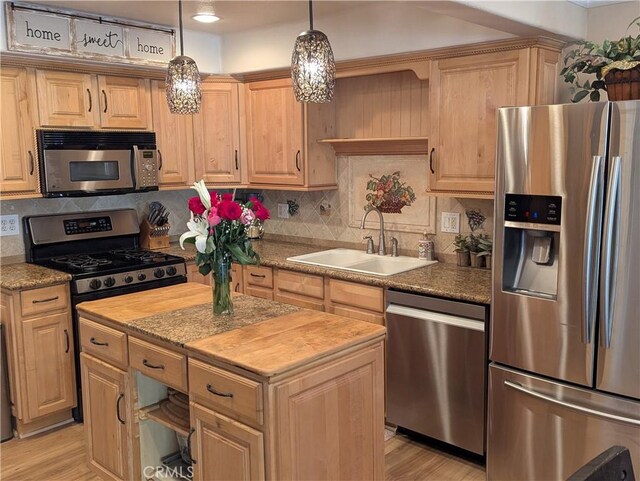306 Vista Trucha, Newport Beach, CA 92660 - kitchen with appliances with stainless steel finishes, a sink, light wood-type flooring, and a kitchen island