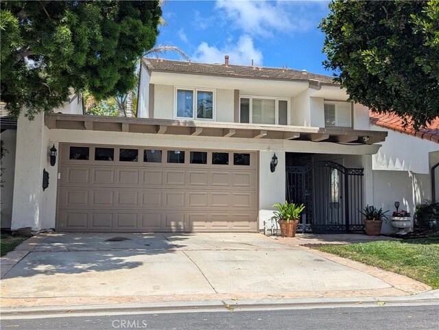 306 Vista Trucha, Newport Beach, CA 92660 - view of front of home featuring stucco siding, driveway, and a garage