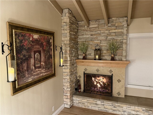 306 Vista Trucha, Newport Beach, CA 92660 - unfurnished living room with beamed ceiling, wood finished floors, a warm lit fireplace, baseboards, and wood ceiling