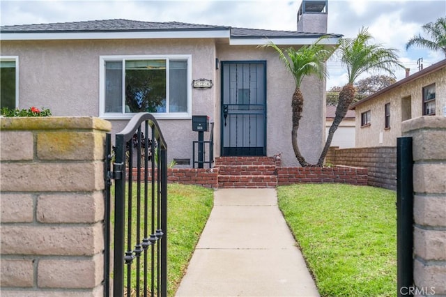 524 N Paulina Ave, Redondo Beach, CA 90277 - property entrance with a gate, stucco siding, and a chimney