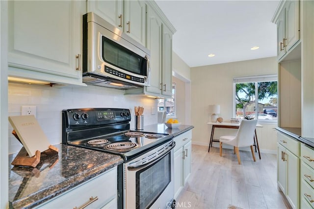 524 N Paulina Ave, Redondo Beach, CA 90277 - kitchen featuring appliances with stainless steel finishes, light wood-type flooring, backsplash, dark stone counters, and recessed lighting