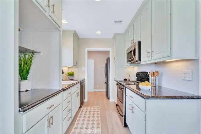 524 N Paulina Ave, Redondo Beach, CA 90277 - kitchen featuring appliances with stainless steel finishes, light wood-style floors, tasteful backsplash, dark stone countertops, and recessed lighting