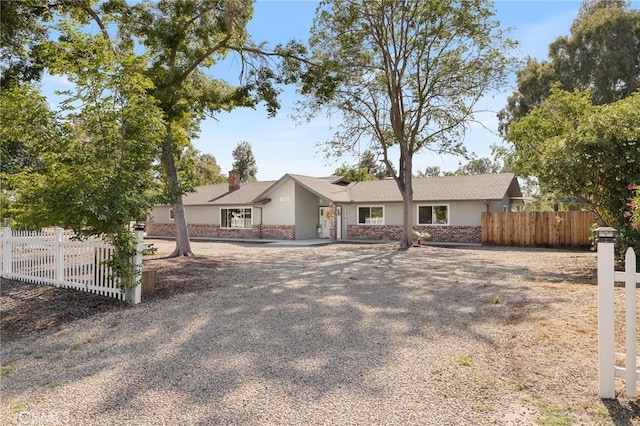 8151 Chamise Ave, Clovis, CA 93619 - view of front of house with fence, a chimney, and stucco siding
