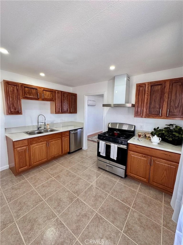 640 Flora St, Barstow, CA 92311 - kitchen featuring appliances with stainless steel finishes, a sink, wall chimney range hood, light countertops, and recessed lighting