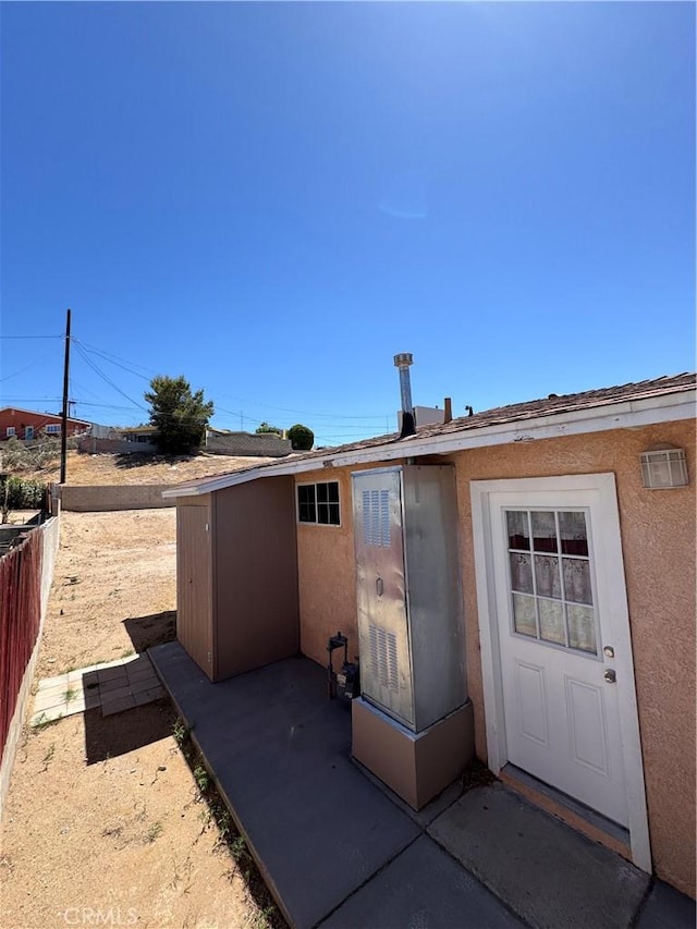 640 Flora St, Barstow, CA 92311 - rear view of house featuring stucco siding and a patio area