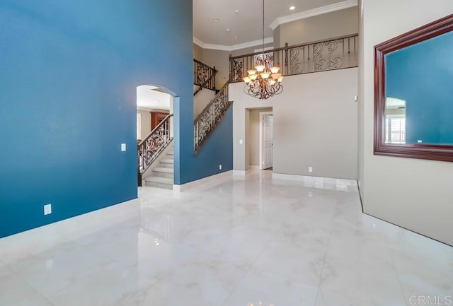 475 Marsh Harbor Dr, San Diego, CA 92154 - unfurnished room with crown molding, arched walkways, a chandelier, stairs, and a towering ceiling