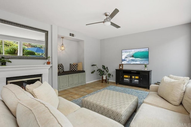 6628 Sitio Sago, Carlsbad, CA 92011 - living room with ceiling fan, a glass covered fireplace, and baseboards
