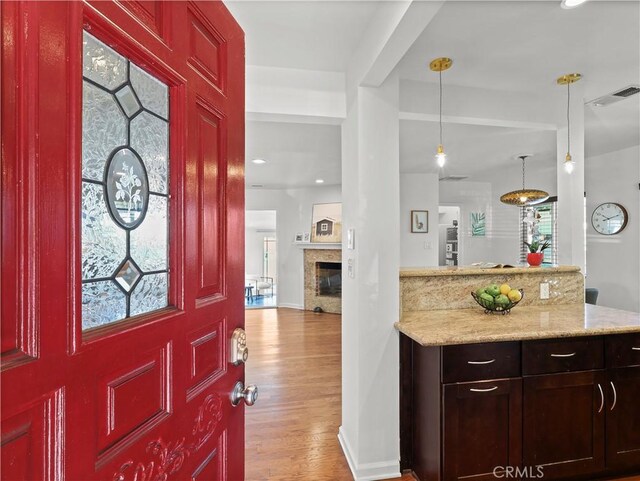 8110 Lesner Ave, Lake Balboa, CA 91406 - foyer featuring light wood-style flooring, a glass covered fireplace, plenty of natural light, and recessed lighting