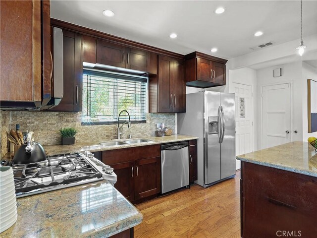 8110 Lesner Ave, Lake Balboa, CA 91406 - kitchen featuring stainless steel appliances, light stone counters, tasteful backsplash, recessed lighting, and light wood finished floors